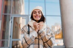 Woman in winter gear outside with a big smile